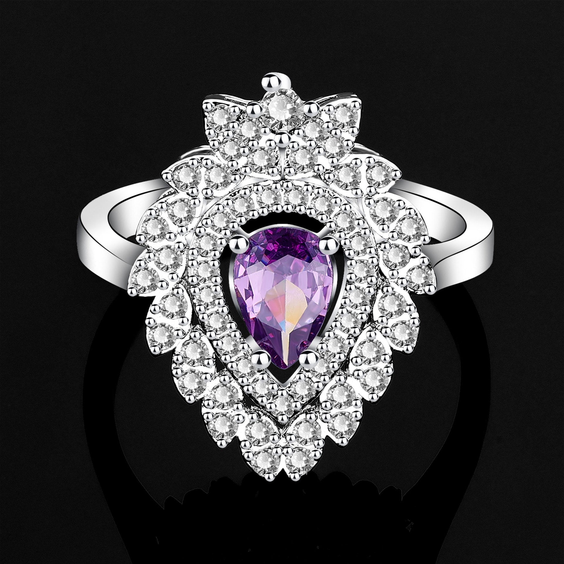 Silver ring with a purple gemstone on a black background