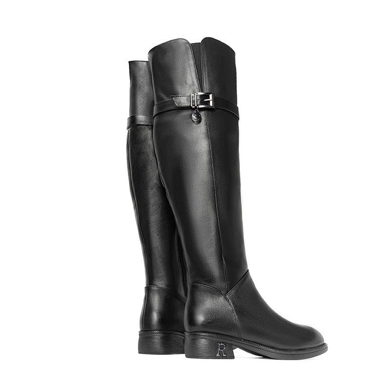 Black knee-high boots with a strap on a white background