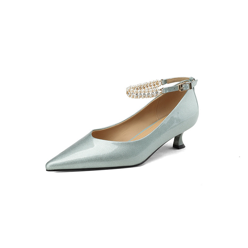 Silver high-heeled shoe with a pearl strap on a white background