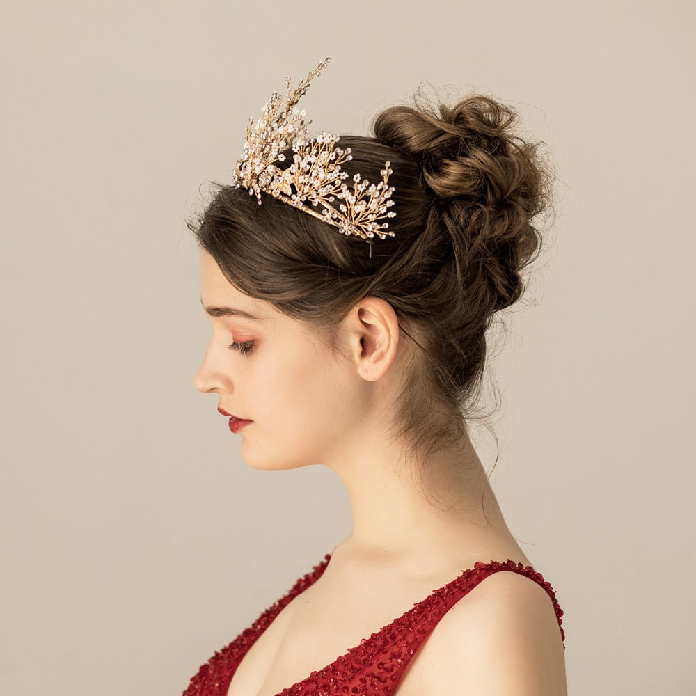 Woman wearing a decorative headpiece with a plain background