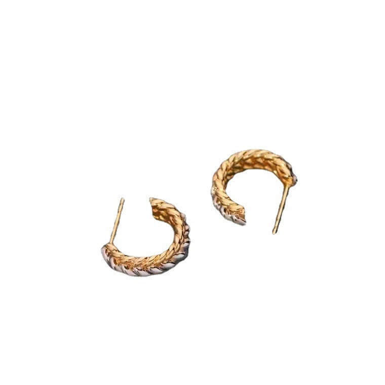 Pair of gold hoop earrings on a white background