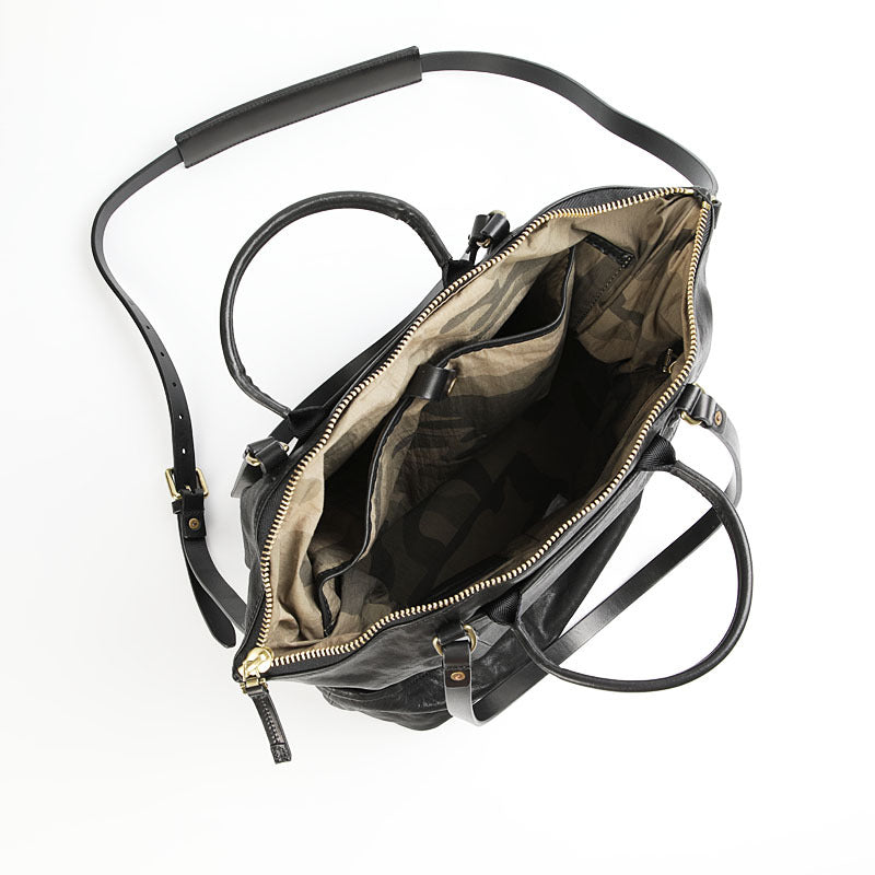 Black leather backpack with gold zipper on a white background