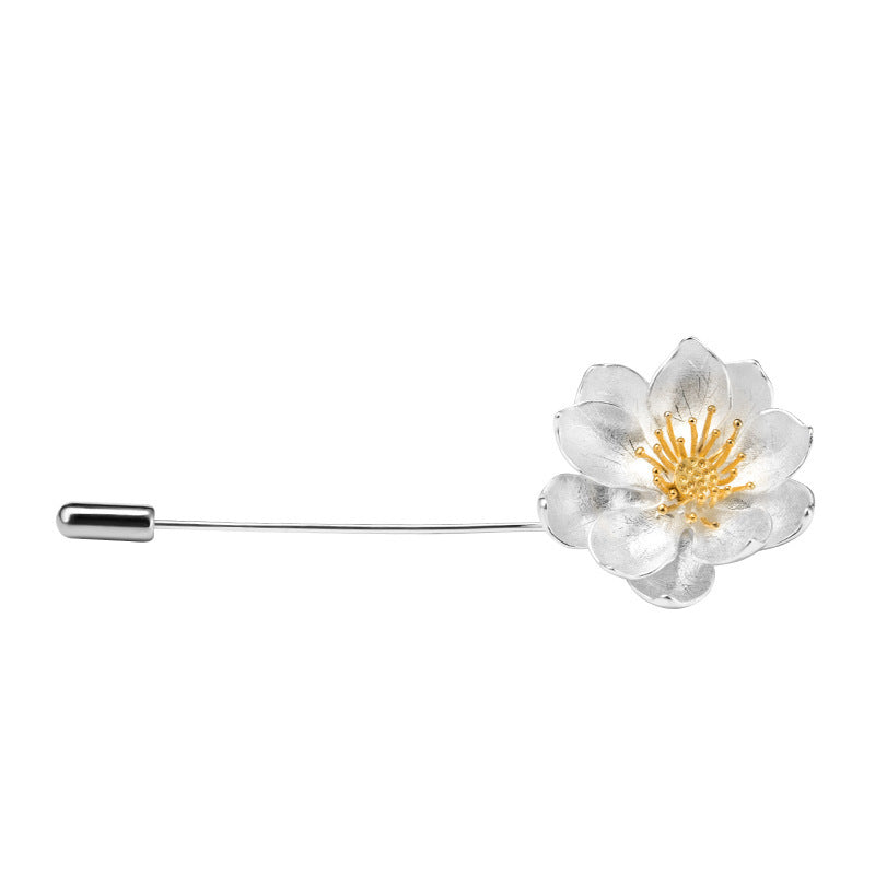 Floral brooch with gold center on a white background