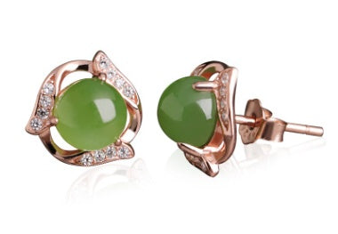 Pair of green gemstone earrings with rose gold accents on a white background