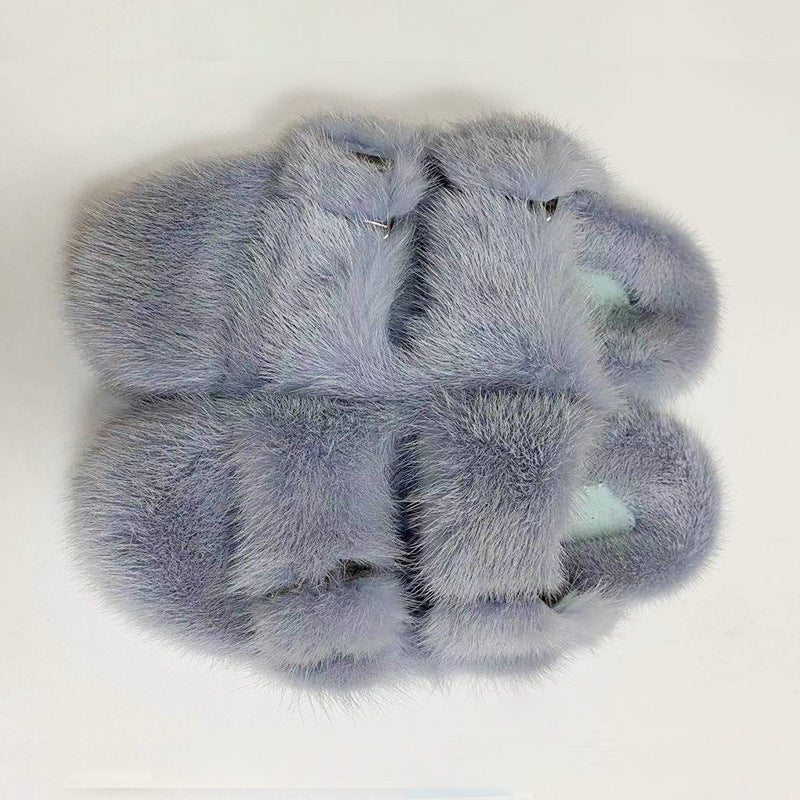 Pair of gray fuzzy slippers on a white background