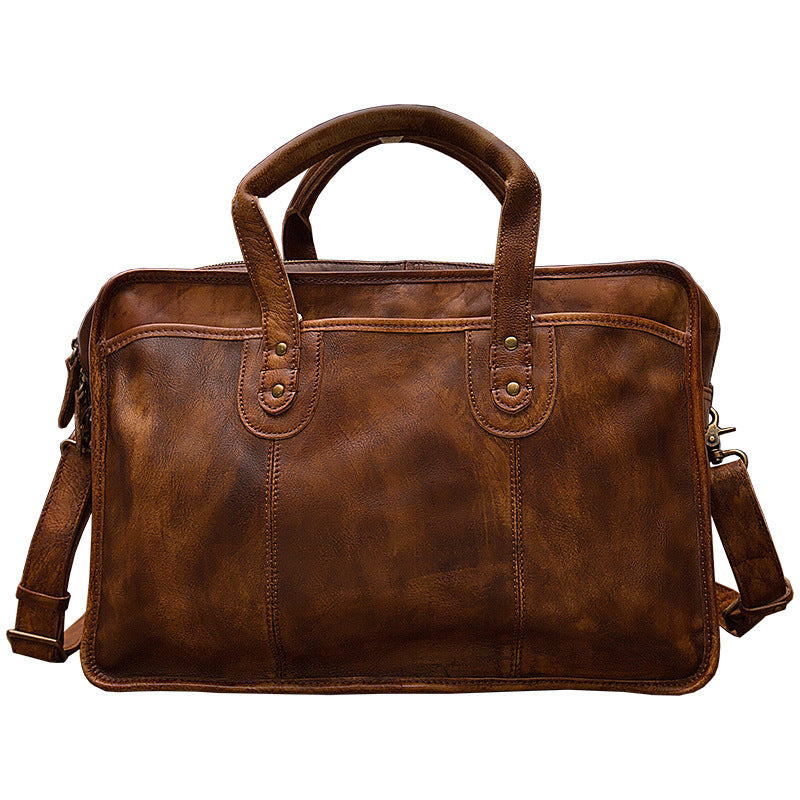Brown leather briefcase with shoulder strap on a white background
