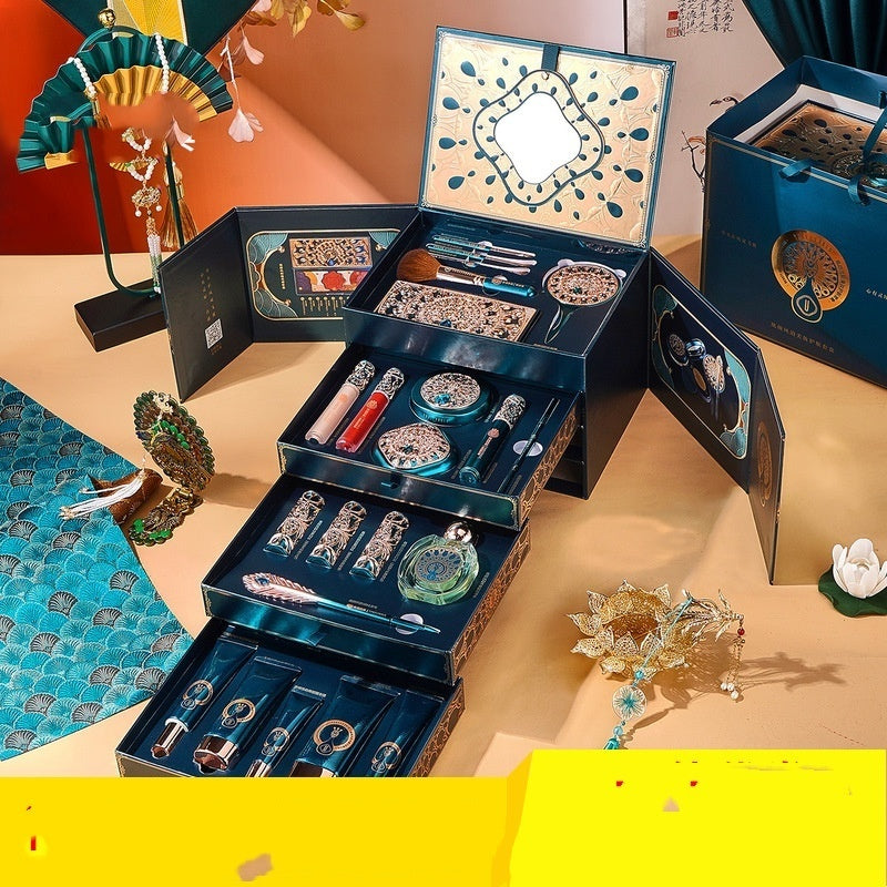 Open jewelry box with various decorative items on a table
