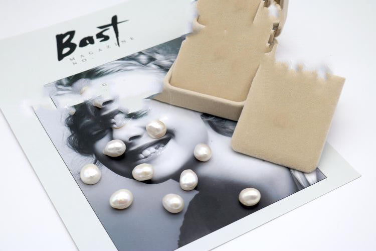 Pearls on a black and white photo with 'Bast' branding