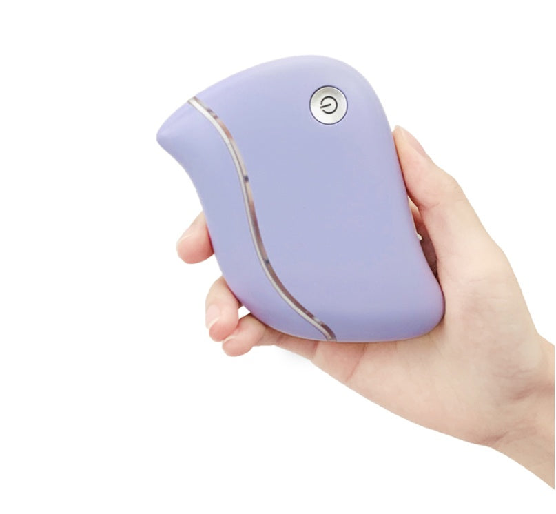 Hand holding a purple handheld device on a white background
