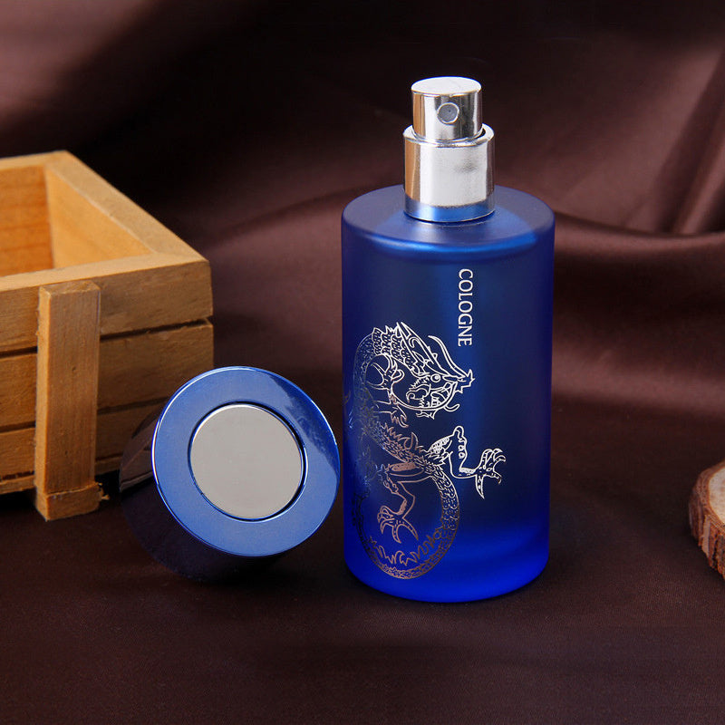 Blue cologne spray bottle with silver cap on a brown background