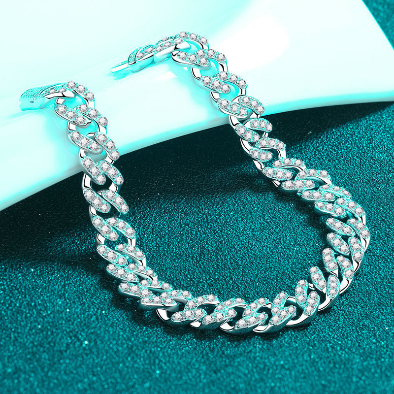 Silver chain necklace with clear stones on a teal background