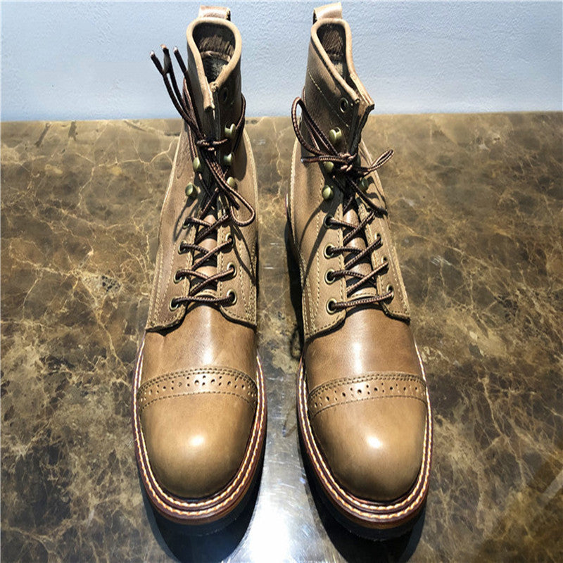 Pair of brown leather boots on a marble surface
