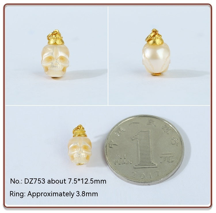 Gold and pearl skull-shaped pendant with size reference on a white background
