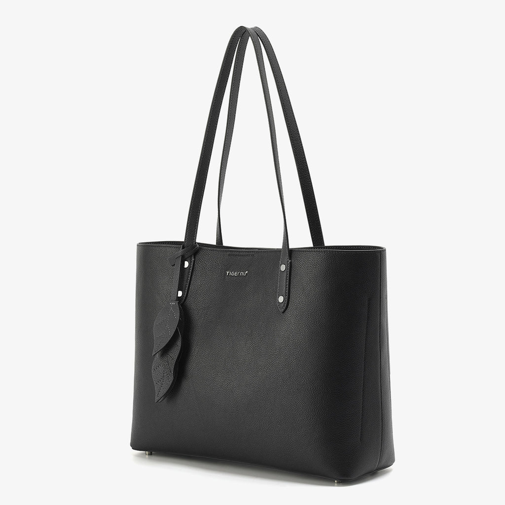 Black tote bag with a visible brand logo on a white background