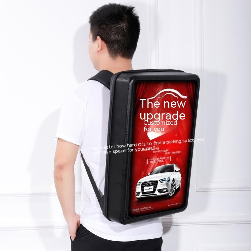 Person wearing a backpack with a promotional advertisement on a white background