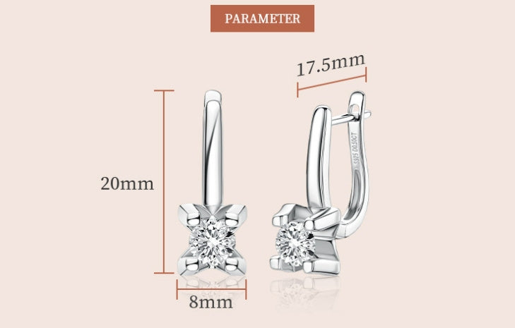 Silver earrings with clear gemstones, shown with measurements on a light pink background.