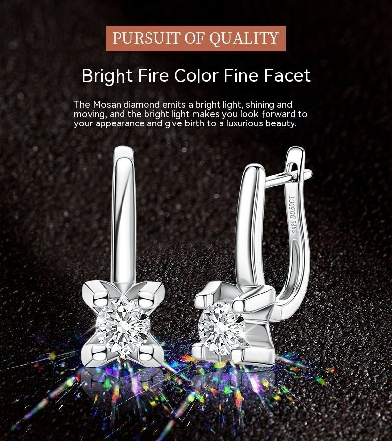 Silver earrings with diamond accents on a dark background with text about Mosan diamonds.