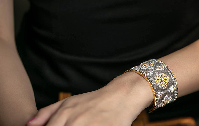 Decorative bracelet on a wrist with a dark background