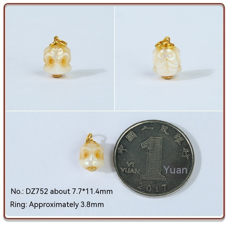 Pearl pendant with gold setting next to a Chinese yuan coin for size comparison on a light blue background.