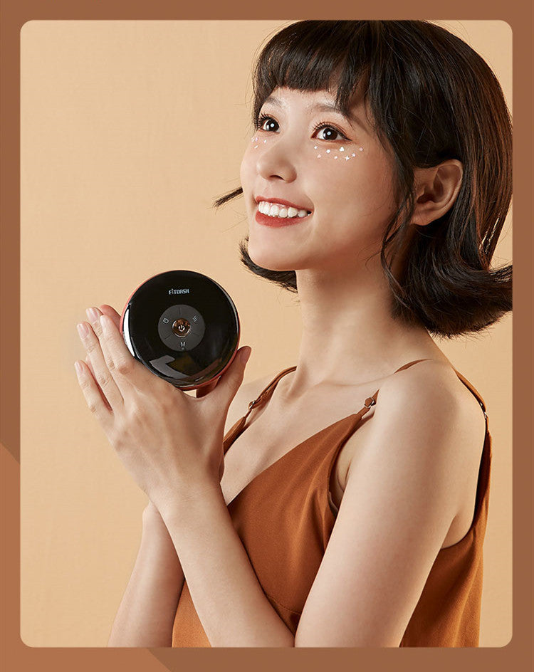 Woman holding a black round device against a beige background