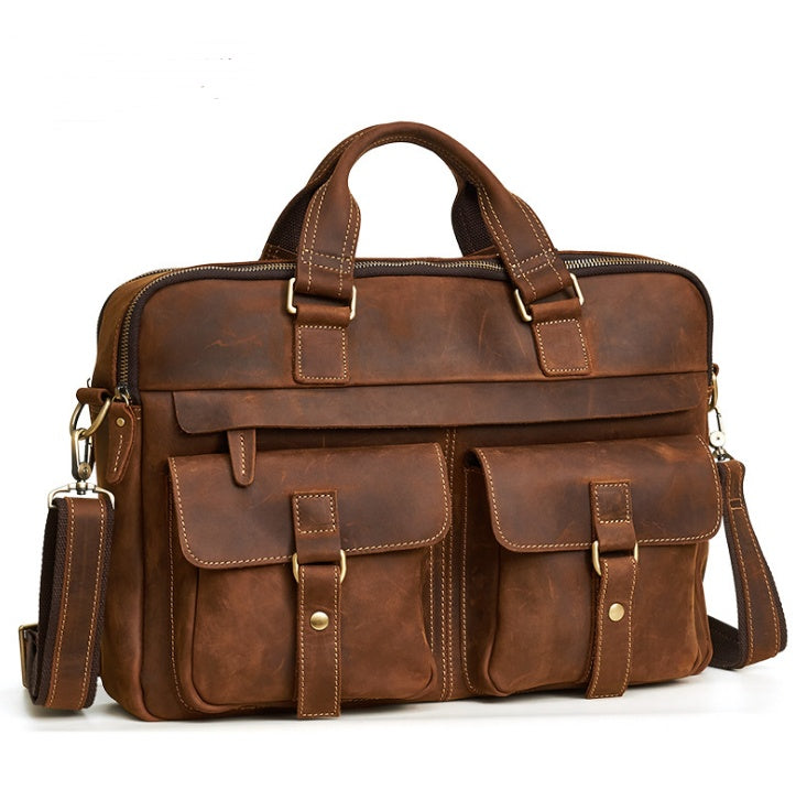 Brown leather briefcase with multiple pockets and straps on a white background