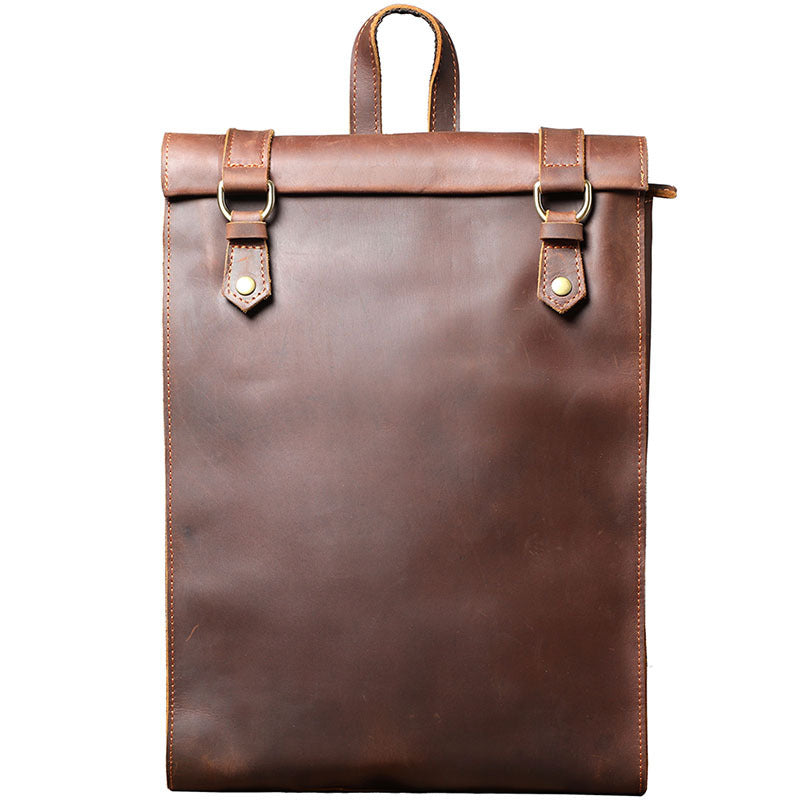 Brown leather backpack with gold buckles on a white background