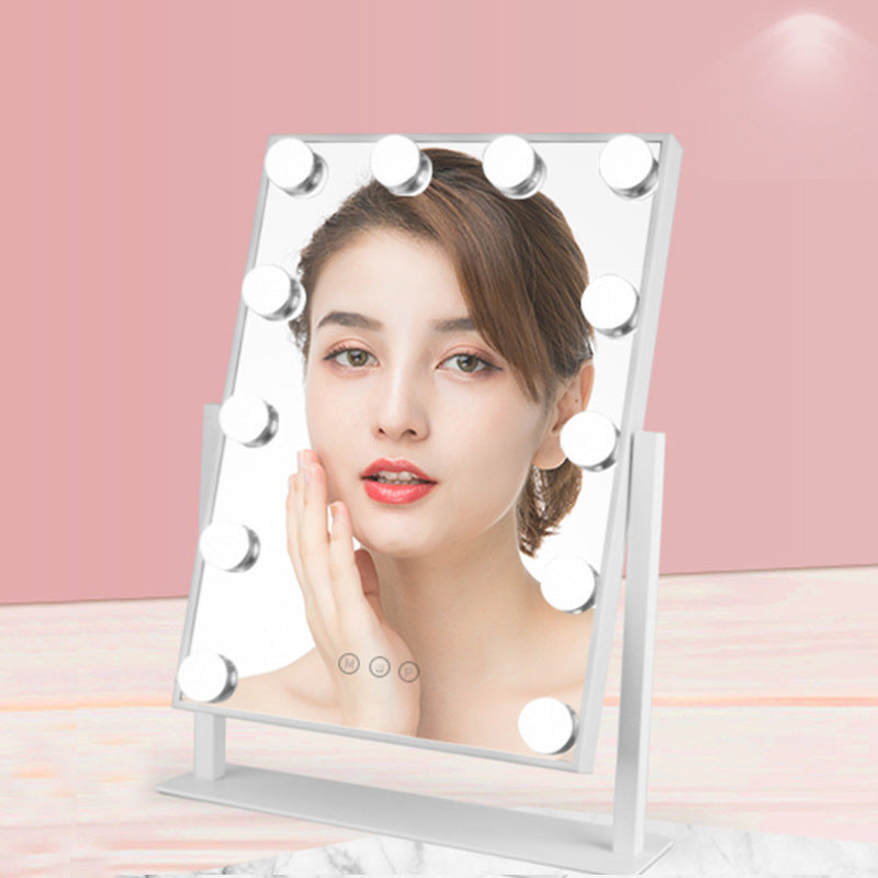 Makeup mirror with lights on a pink background