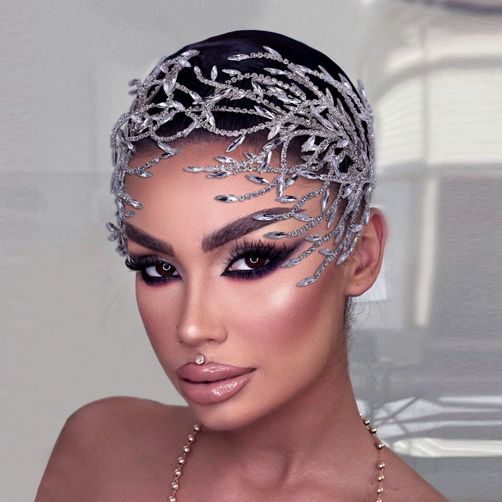 Woman wearing a decorative headpiece with intricate designs.