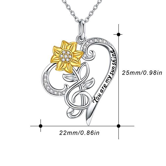 Jewelry pendant with gold flower and silver heart with 'You are my sunshine' engraving, measurements shown.