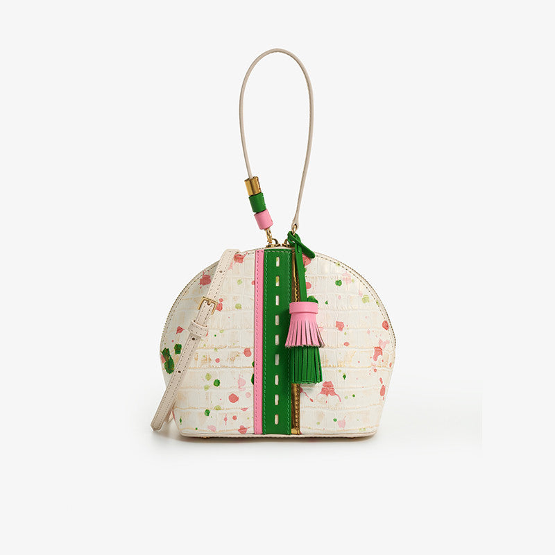 Small round bag with colorful design and tassel on a white background