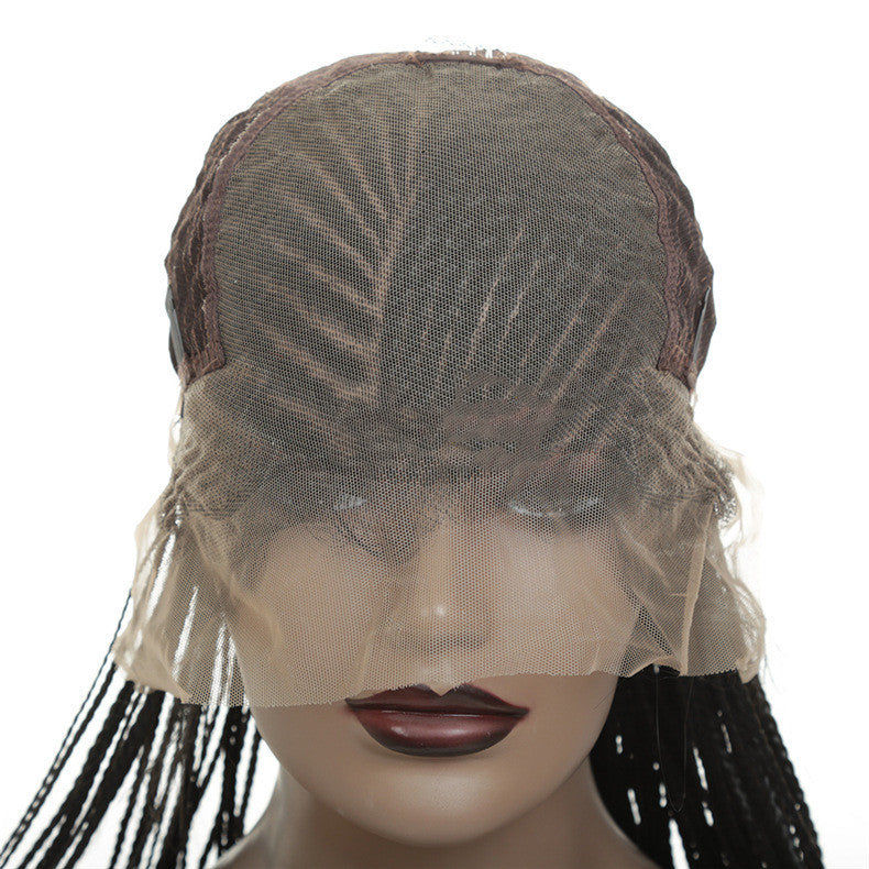 Mannequin head with a wig featuring braided hair on a white background