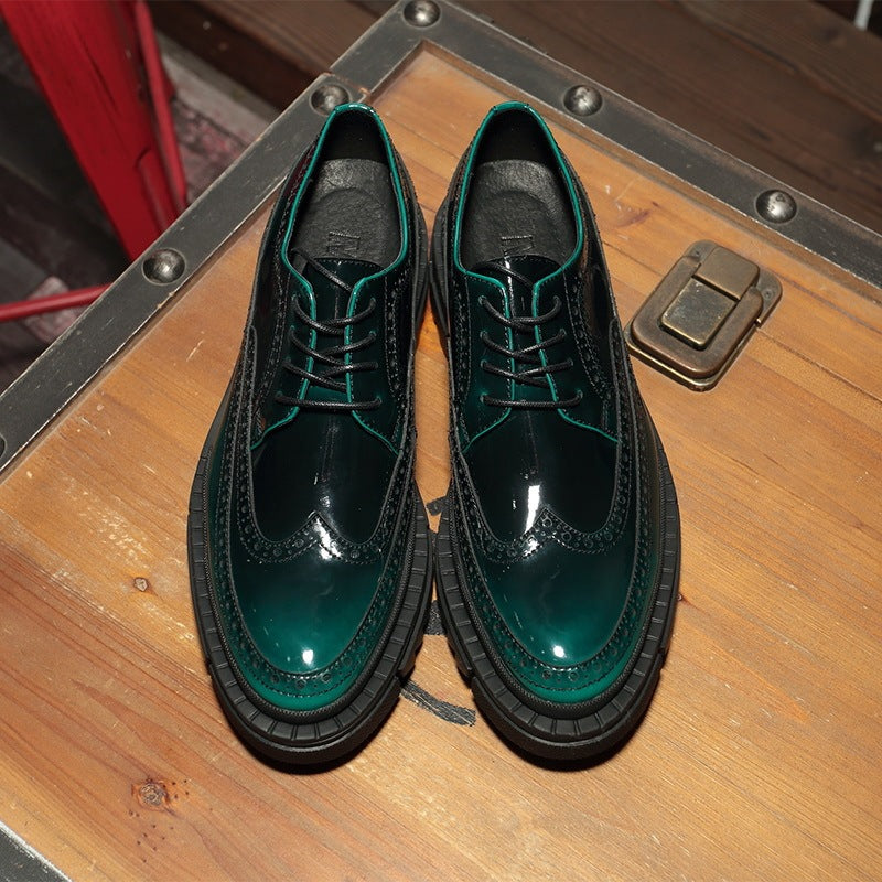 Pair of green and black shoes on a wooden surface