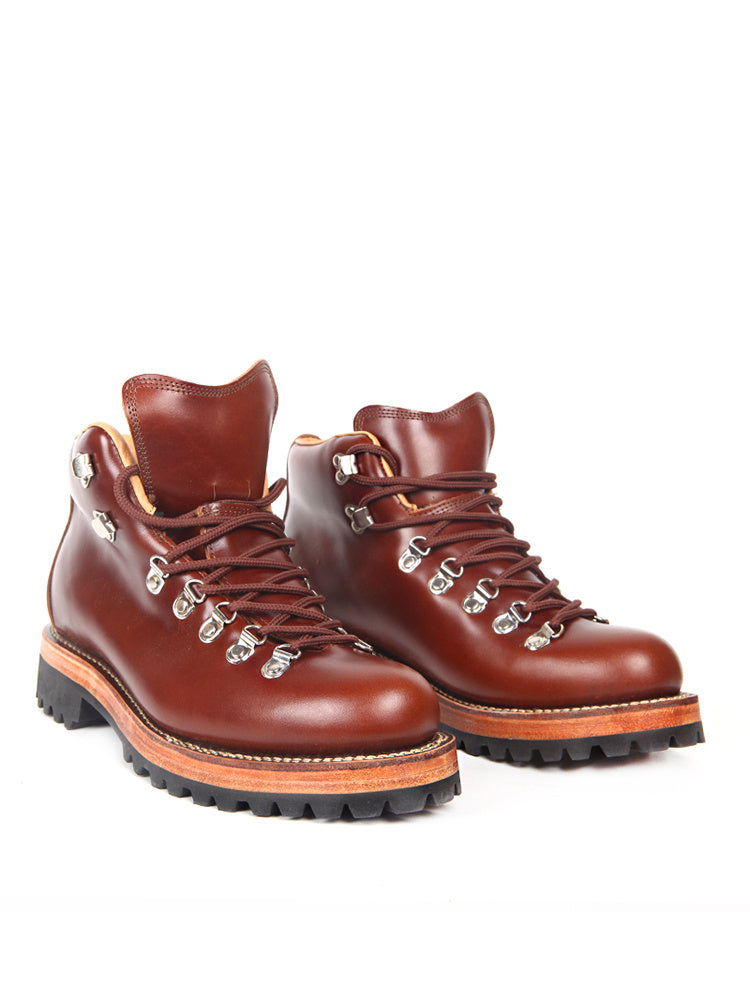 Pair of brown leather hiking boots with orange accents on a white background