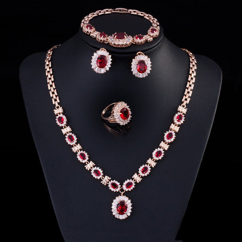 Jewelry set with necklace, earrings, and ring on a black stand