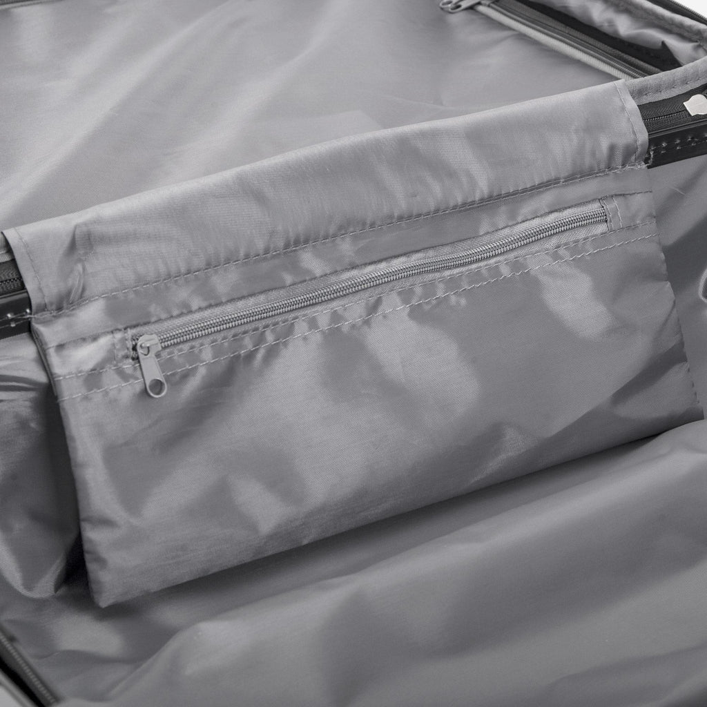 Close-up of a gray fabric with zippers on a product, likely a bag or jacket.