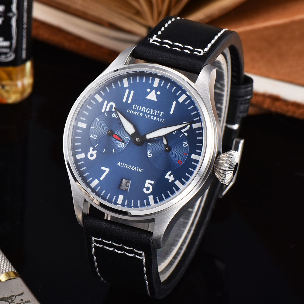 Watch with blue dial and black leather strap on a dark background