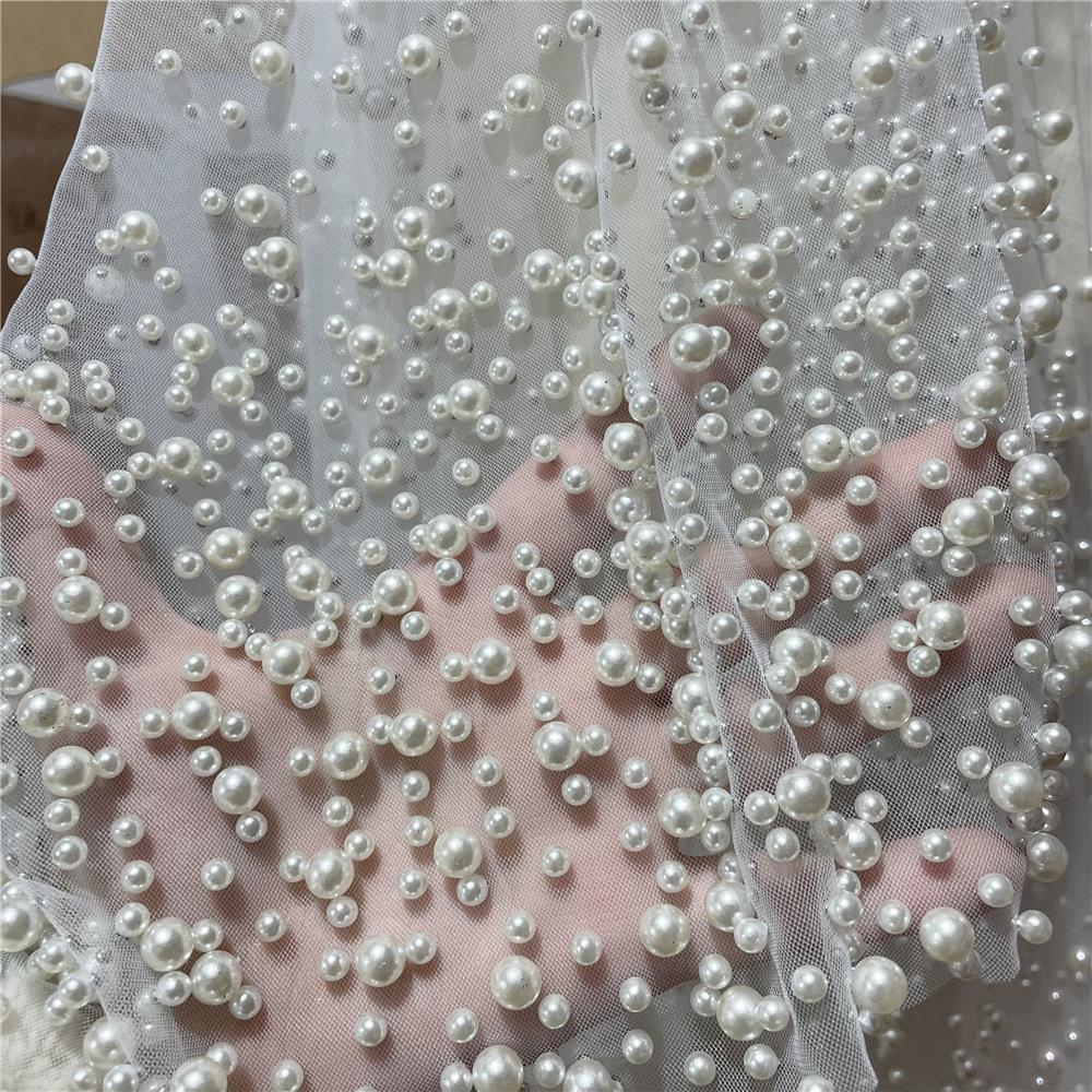 Close-up of white pearl fabric on a sheer background