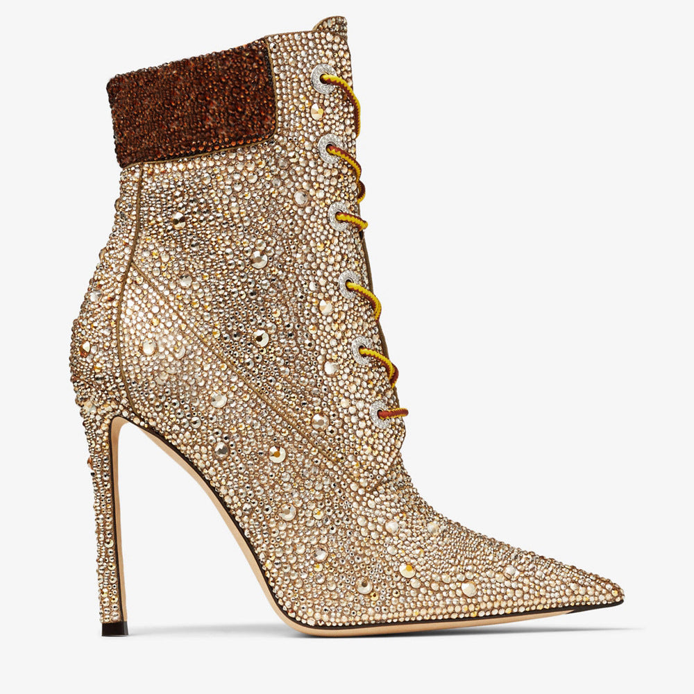 Elevated high-heeled stiletto boot with intricate detailing on a white background