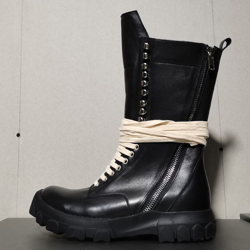 Black leather boot with white rope tied around it against a neutral background