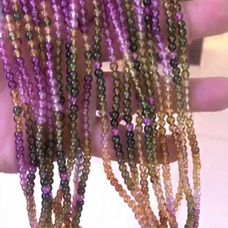 Close-up of multiple strands of beaded necklaces with a blurred background