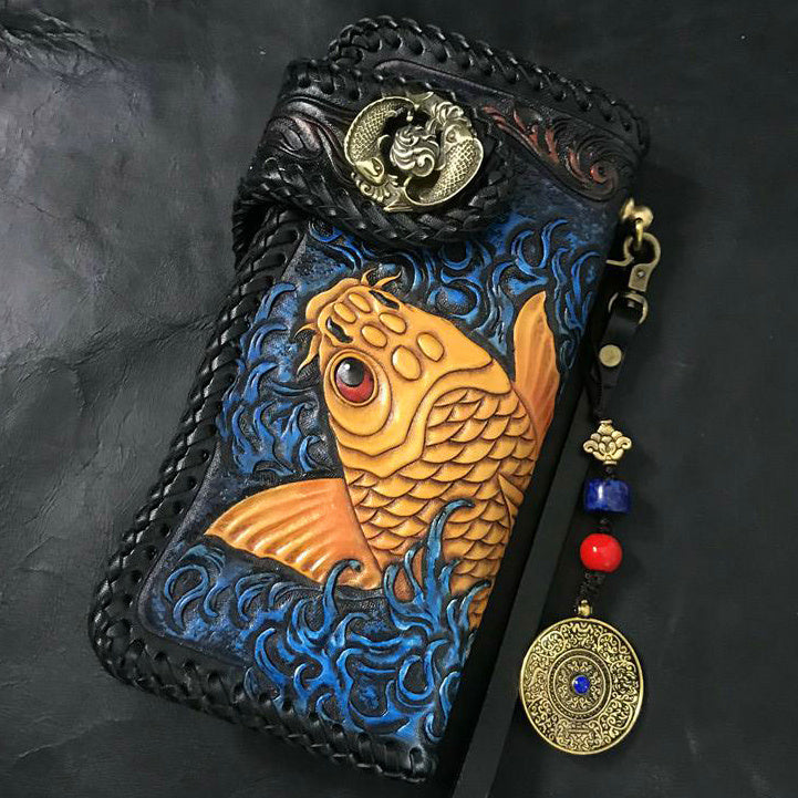 Handcrafted leather wallet with gold fish design on a dark background