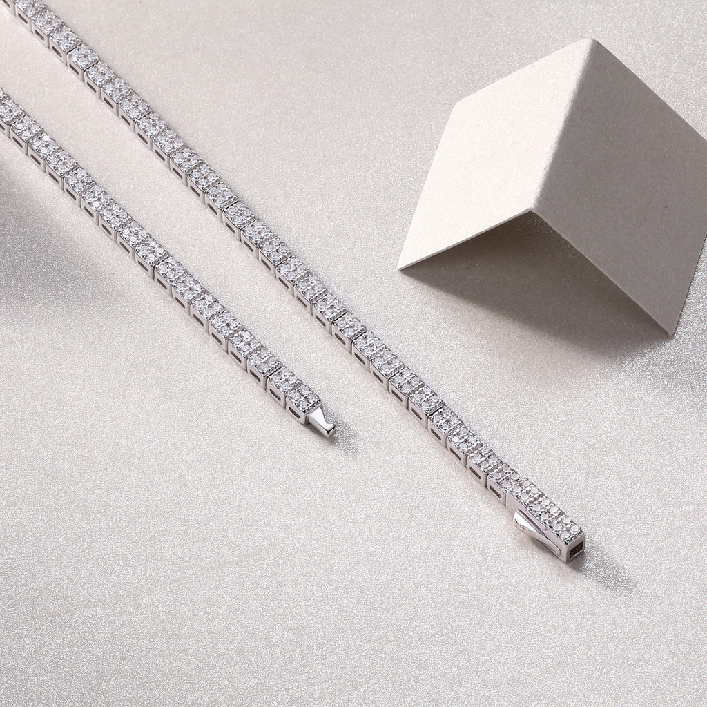 Silver bracelet with diamond accents on a light gray surface