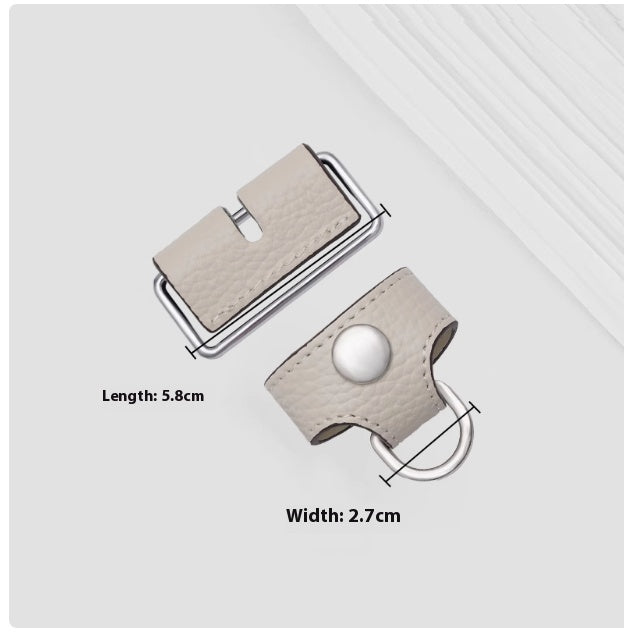 Beige leather belt buckle with measurements on a light gray background