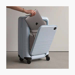 Suitcase with a compartment for a laptop inside, on a neutral background