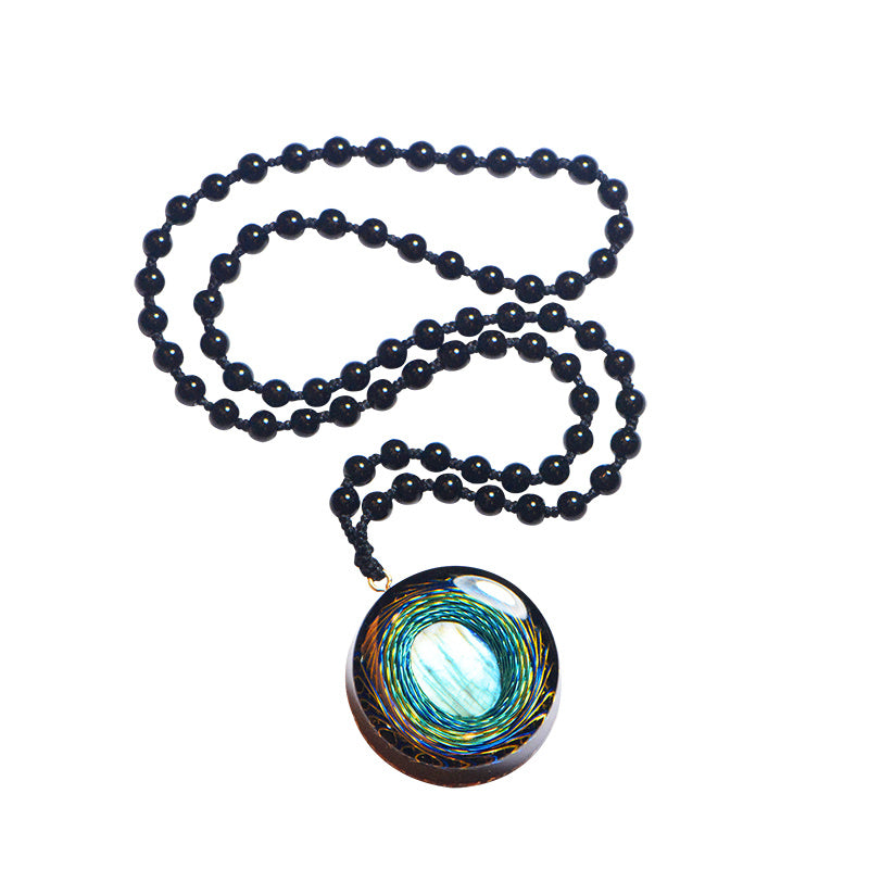 Necklace with a black beaded chain and a colorful pendant on a white background