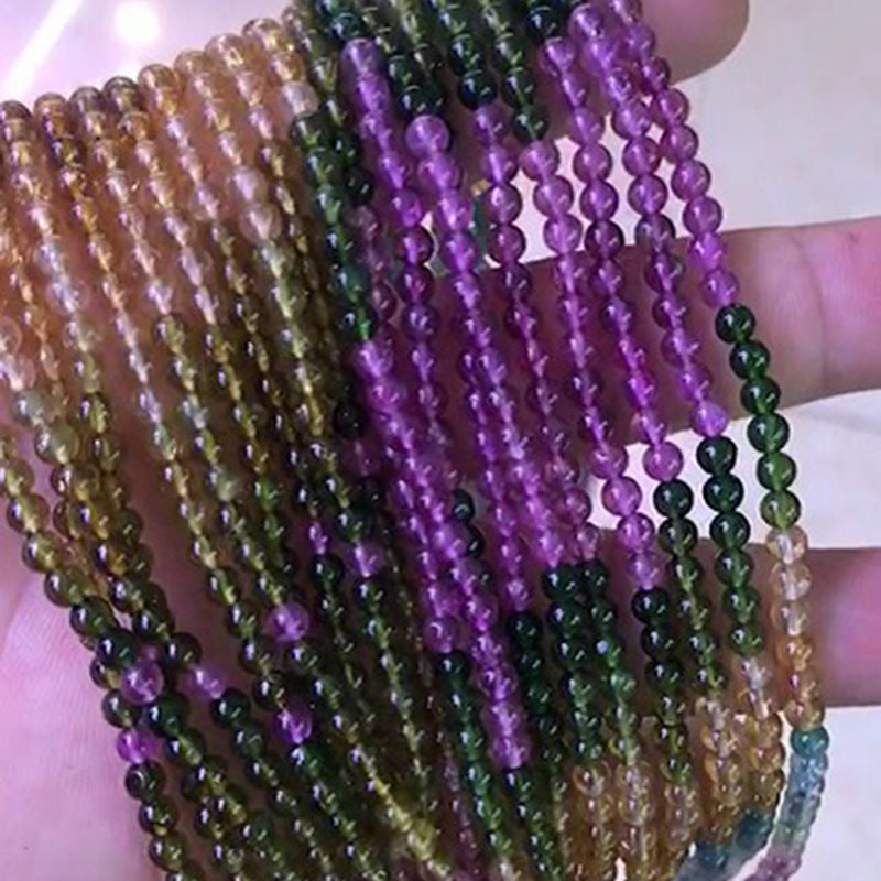 Close-up of multicolored beaded bracelets held together.