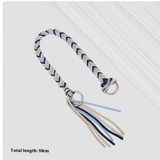 Braided dog toy with tassels on a white background