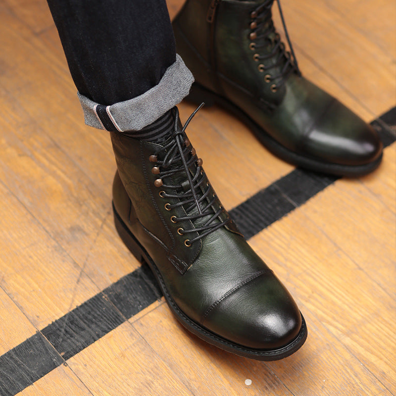 Green leather boots worn on a wooden floor