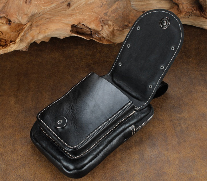 Black leather wallet open on a rustic wooden surface