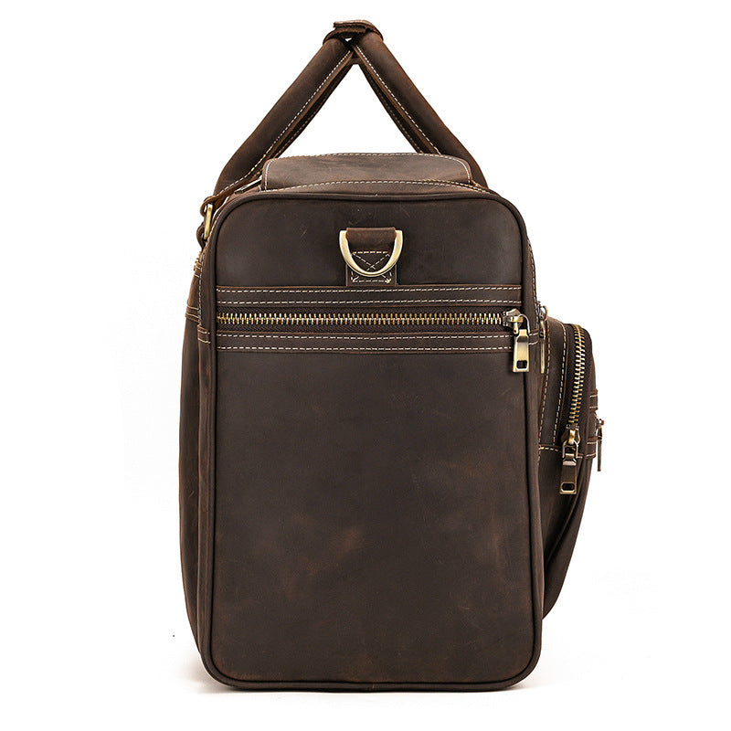 Brown leather bag with gold zippers on a white background